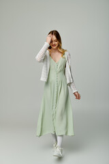 Stylish young woman embraces spring fashion with a charming pastel dress and chic cardigan