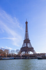 Fototapeta premium Paris, France - February 23, 2025: Eiffel Tower on the Seine River in Paris, France, early spring