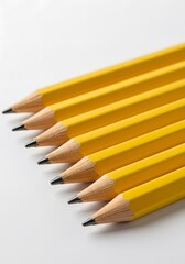 Close-up of six sharpened yellow pencils arranged on white background, Yellow pencils arranged neatly on a white background create a simple yet striking visual effect during morning daylight.