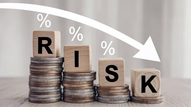 a concept related to reducing business risks, showcasing a gradual decrease in risk levels with stacks of coins. The blocks spelling out "RISK" suggest a business strategy to minimize financial risk