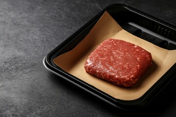 Raw Beef Steak in Black Tray on Dark Countertop Ready for Cooking