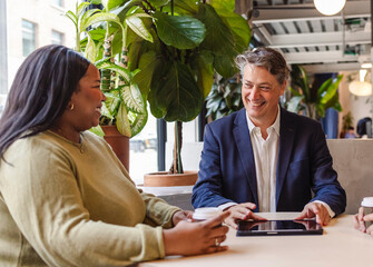 Business people having a meeting using tablet in modern office