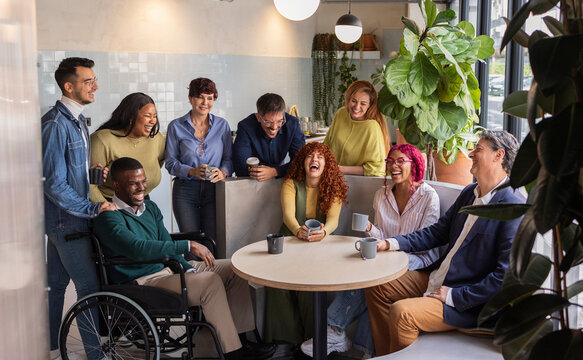 Diverse business team enjoying coffee break in modern office