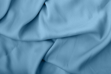Luxury fabric texture in soft blue color with soft flowing folds and creases