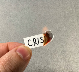 The word “CRISIS” on a burning piece of paper