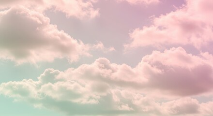 Obraz premium Soft pastel clouds drifting across a serene sky during a tranquil sunset