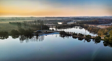 Scenic Aerial View of Calm Lake and Frosty Winter Landscape at Sunrise, Hedensted, Denmark