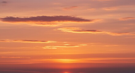 Fototapeta premium Serene sunset over calm ocean waters with soft clouds in the sky