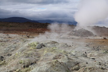 Vapor clouds and colorful rocks in Namaskjard geothermal area in Iceland