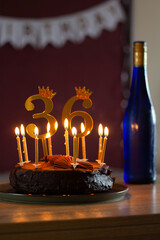 Birthday Celebration 36 with Cake and Candles. A beautifully decorated chocolate cake with burning...