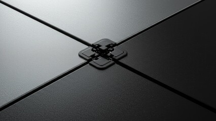 Close-up of gray and black access floor tiles with a connector.