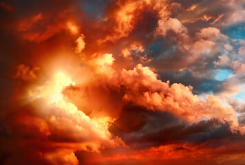 Vivid orange sky with dramatic clouds and sunbeam glow. Real shot as fantasy concept with majestic inspiring light