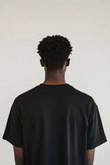Obraz premium Back shot of young African American man wearing a black t-shirt