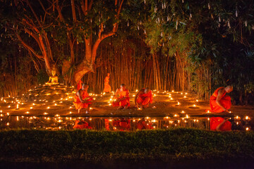 Makha Bucha (Magha Puja) celebrations, monks pray under illuminated Buddha statue annually at Wat Phan Tao temple, Chiangmai, Thailand