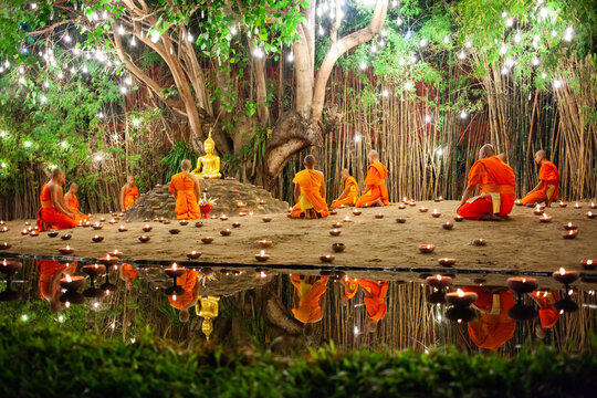 Makha Bucha (Magha Puja) celebrations, monks pray under illuminated Buddha statue annually at Wat Phan Tao temple, Chiangmai, Thailand