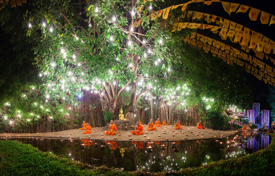 Makha Bucha (Magha Puja) celebrations, monks pray under illuminated Buddha statue annually at Wat Phan Tao temple, Chiangmai, Thailand