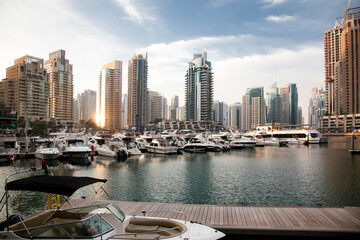 View of modern skyscrapers shining in sunrise light in Dubai Marina in Dubai, United Arab Emirates