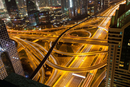 Night traffic on a busy intersection on Sheikh Zayed highway, Dubai, United Arab Emirates
