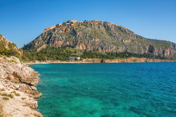 Arvanitias beach in historic city of Nafplion with Palamidi fortress on top of the mountain, Nafplion, Peloponnese
