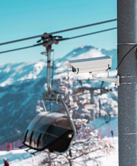 Surveillance camera monitoring ski slope with snowy mountains in background. In Folgarida
