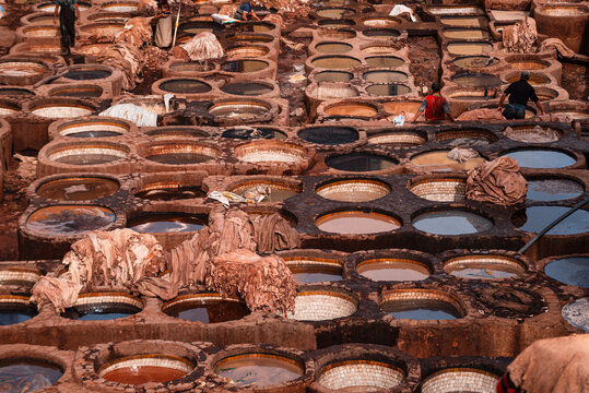 Rows of dye-filled stone basins in a traditional leather tannery in Fes