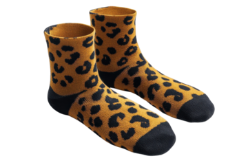 A pair of cozy ankle socks boasting a playful leopard print in warm mustard yellow and deep charcoal, perfect for adding a touch of wild style to any outfit.