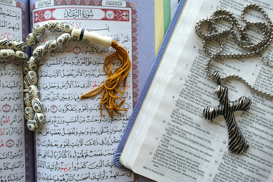 Holy Quran with Muslim prayer beads and Bible with rosary, Interfaith symbols between Christianity and Islam, Ho Chi Minh City