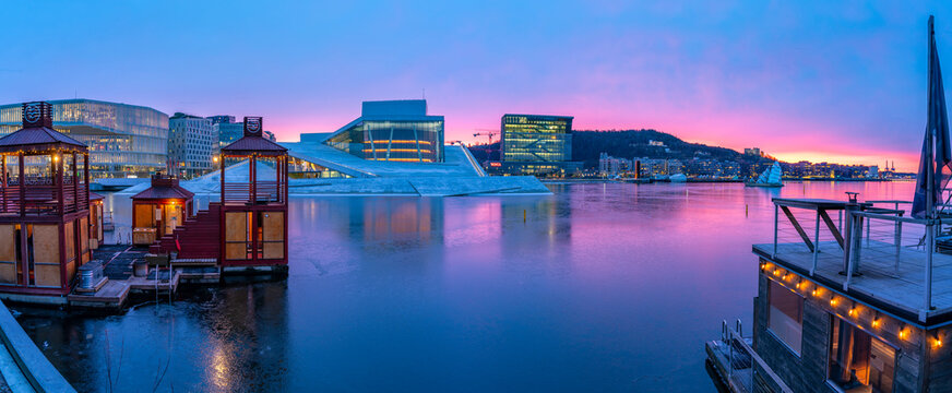 View of Opera House and harbourside saunas during winter at sunrise, Oslo, Norway