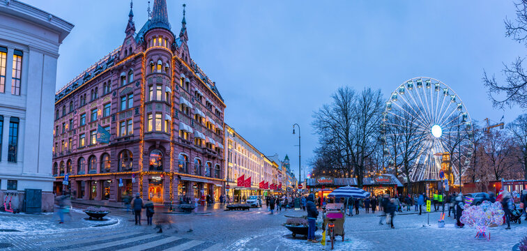 View of architecture on Karl Johans Gate and Christmas market during winter at dusk, Oslo, Norway
