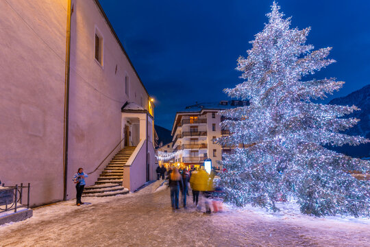 View of Christmas tree and decorations in Piazza Abbe Henry at dusk, Courmayeur, Aosta Valley