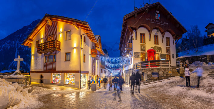 View of Christmas lights and decorations in Piazza Abbe Henry at dusk, Courmayeur, Aosta Valley