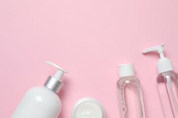 Natural cosmetic products on a pink background, top view