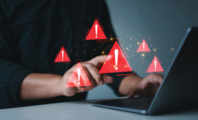 Businessman using laptop with spam virus with warning to alert internet security and data breach or hacker or spyware.