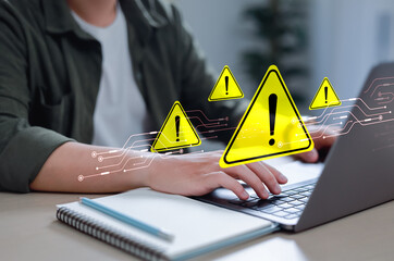 Businessman using laptop with spam virus with warning to alert internet security and data breach or hacker or spyware.