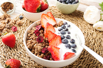 Muesli with organic berries and nuts. Oat muesli with raspberry, blueberry, strawberries, almond, cashew, banana. Healthy food, top view