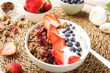 Muesli with organic berries and nuts. Oat muesli with raspberry, blueberry, strawberries, almond, cashew, banana. Healthy food, top view