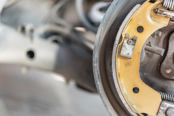 Drum brake and asbestos brake pads at car garage