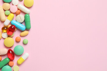 Various pills on color background, top view