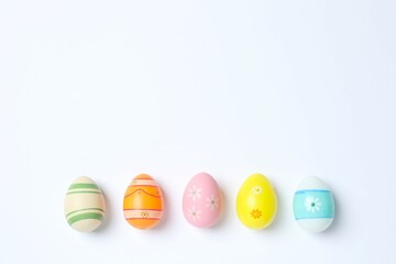 Happy Easter. Colorful eggs on white background, space for text or advertising