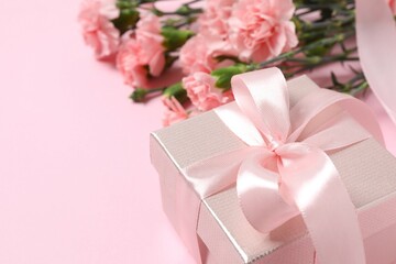 Beautiful bouquet of pink carnations on a colored background