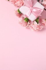 Beautiful bouquet of pink carnations on a colored background