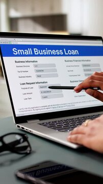 Person Hand Over Small Business Loan Application