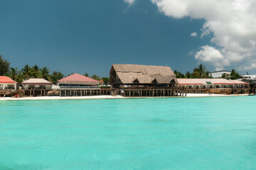 Traditional restaurants line the coast of zanzibar, inviting tourists to enjoy delicious meals with stunning ocean views
