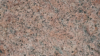Natural granite surface texture, speckled for backgrounds or design projects, close-up.