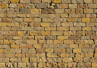 Obraz premium 黄金色煉瓦壁 温かい光に照らされ 美しく並ぶ