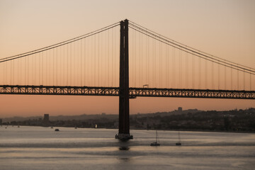 Breathtaking suspension bridge Lisbon skyline views from balcony of modern cruiseship cruise ship liner during sunset twilight blue hour