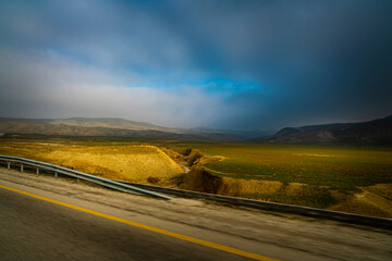 View of a pretty landscape from a moving vehicle in the foreground
