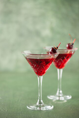 Cherrytini. Red alcoholic cherry martini cocktail with cherry garnish in martini glasses
