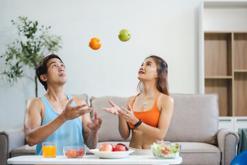 Fit couple enjoys healthy fruit breakfast after yoga training.