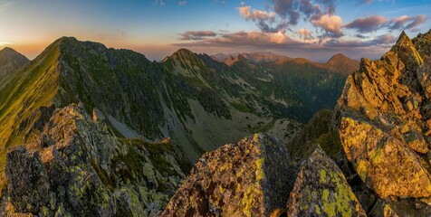 Mountain trail leading along the mountain ridge of beautiful mountains with autumn grass and...